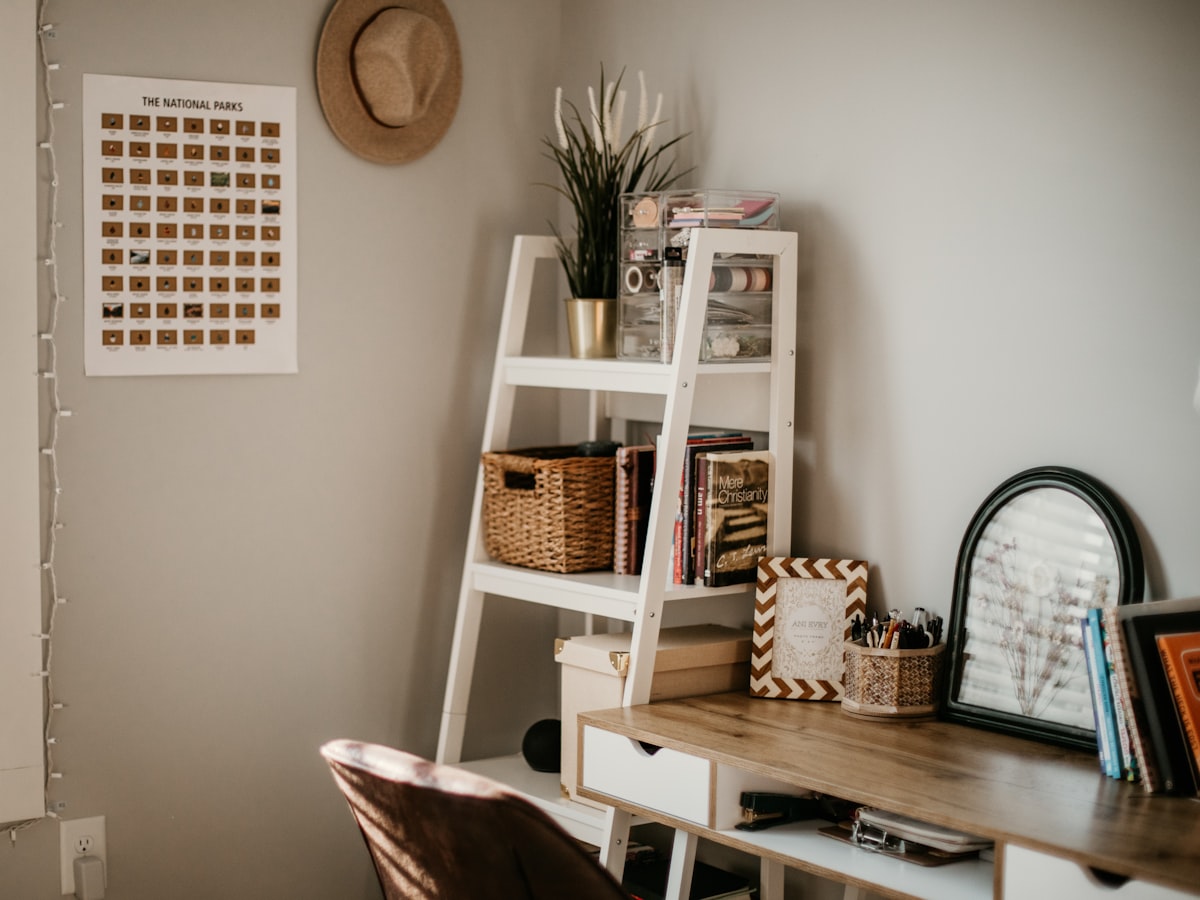 An extended-stay room set up for daily living with a desk and work surface